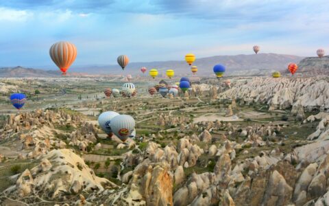 photo of assorted-color air balloon lot in mid air during daytime